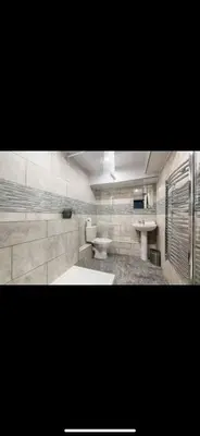 a bathroom with two sinks and two toilets at Stylish Studio Apartment in Liverpool