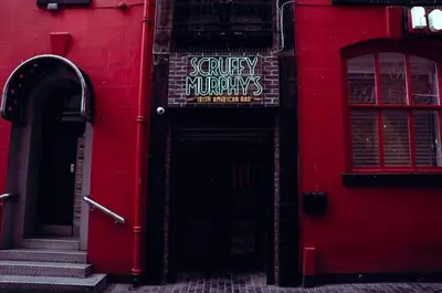a red building with a sign on the door at Stylish Studio Apartment in Liverpool