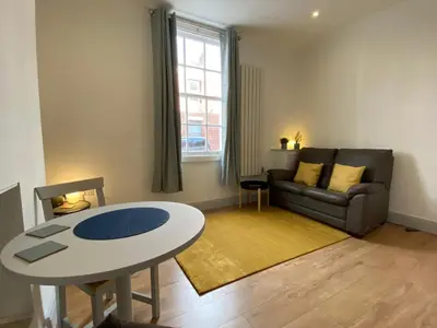 a living room with a table and a couch at Avenham Apartments in Preston