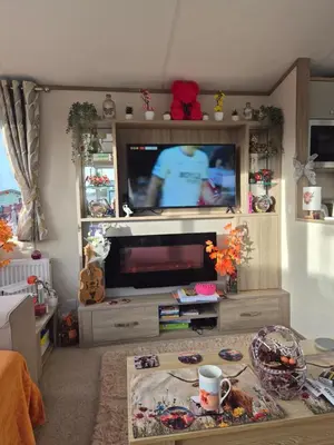 a living room with a flat screen tv in a entertainment center at Hill family residence in Morecambe