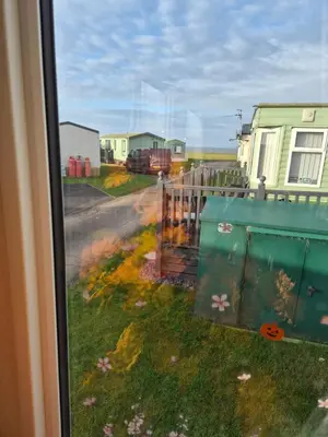 a view from a window of a yard with a fence at Hill family residence in Morecambe