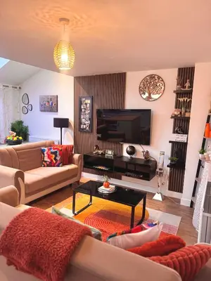 a living room with a couch and a television at Room in Blackburn - Peters Place in Lower Darwen