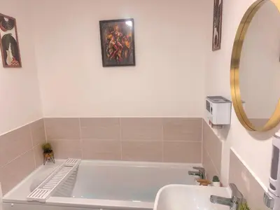 a bathroom with a tub and a sink and a mirror at Room in Blackburn - Peters Place in Lower Darwen