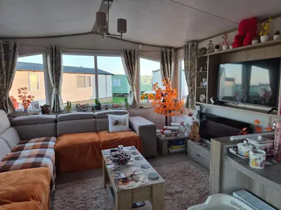a living room with a couch and a tv at Hills residence in Morecambe