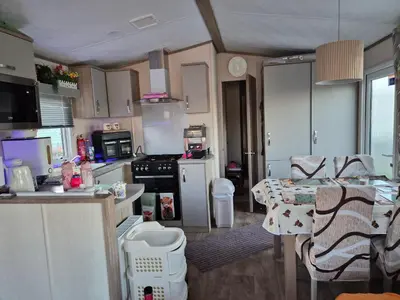 a small kitchen with a table and a counter top at Hills residence in Heysham
