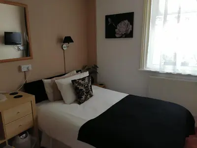 a bedroom with a bed with pillows and a window at The Manhattan in Blackpool