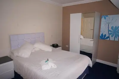 a bedroom with a bed with two towels on it at South Beach Apartments in Blackpool