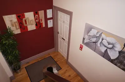 a hallway with a door and a painting on the wall at South Beach Apartments in Blackpool