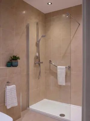 a bathroom with a shower with a glass door at Clifton Arms Hotel in Lytham St Annes