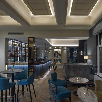 a lobby with tables and chairs and a bar at Clifton Arms Hotel in Lytham St Annes