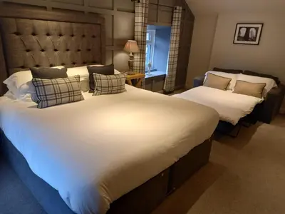 a bedroom with two large beds with white sheets at The Fenwick in Lancaster