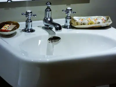 a white bathroom sink with a soap dispenser on it at The Fenwick in Lancaster