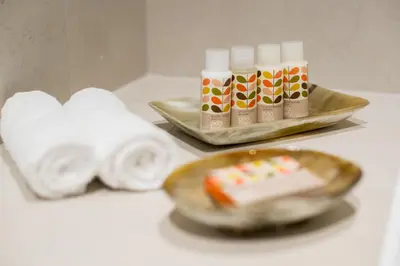 a table with towels and a plate with a piece of cake at The Fenwick in Lancaster