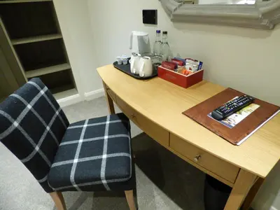 a desk with two chairs and a coffee maker on it at The Fenwick in Lancaster