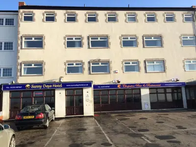 a building with a car parked in front of it at Sunny Days Hotel in Blackpool