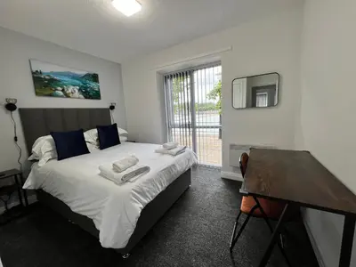 a bedroom with a bed and a desk and a television at Marina Princes Reach in Preston