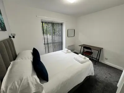 a bedroom with a white bed and a desk at Marina Princes Reach in Preston