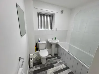 a white bathroom with a toilet and a sink at Marina Princes Reach in Preston