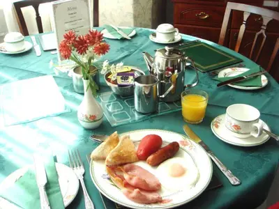 a table with a plate of breakfast food on it at Ashwood Hotel in Preston