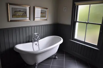 a bath tub in a bathroom with a window at Higher Buck Inn in Waddington