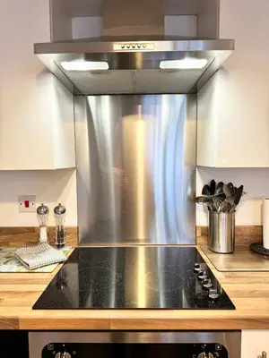 a kitchen with a stainless steel stove top oven at Nordic Suites Apartments, Ulverston in Ulverston