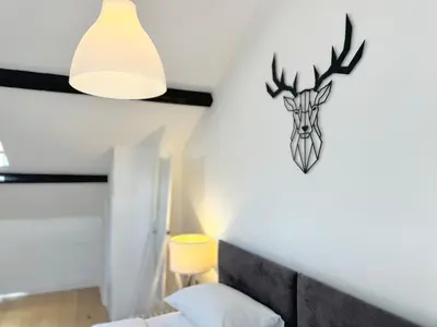 a bedroom with a deer head on the wall at Nordic Suites Apartments, Ulverston in Ulverston