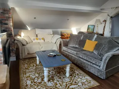 a living room with a couch and a table at Ormsgill Inn in Barrow in Furness