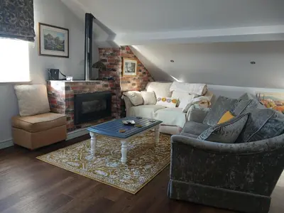 a living room with a couch and a fireplace at Ormsgill Inn in Barrow in Furness