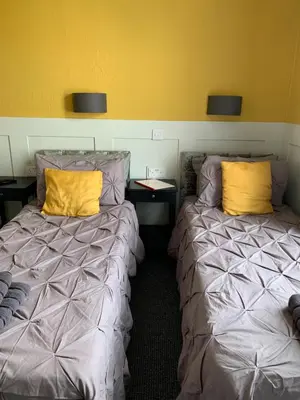 two beds sitting next to each other in a room at The Woodleigh family hotel in Blackpool