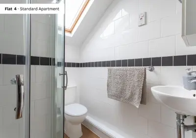 a bathroom with a toilet and a sink at The Chymes Holiday Flats in Lytham St Annes