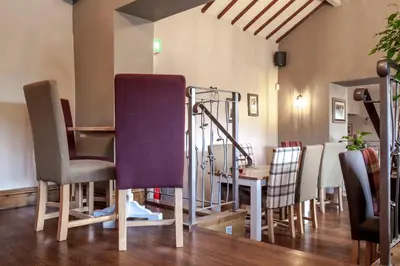 a group of chairs and a table in a room at Crofters Lodge in Barrow in Furness
