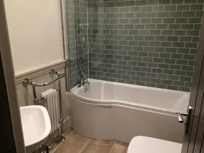a bathroom with a white tub and a sink at Crofters Lodge in Barrow in Furness