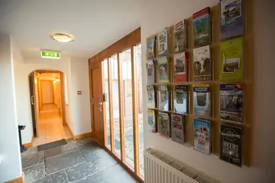 a hallway with many posters on the wall at Parr Hall Farm, Eccleston in Eccleston