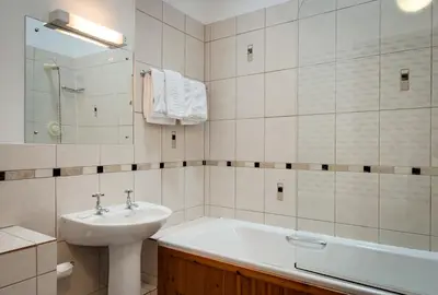 a bathroom with a sink and a bath tub at Parr Hall Farm, Eccleston in Eccleston