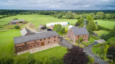 an aerial view of a large brick building on a field at Parr Hall Farm, Eccleston in Eccleston