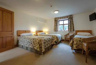 a bedroom with two beds and a window at Parr Hall Farm, Eccleston in Eccleston