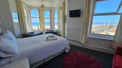 a hotel room with a bed and a view of the beach at Bowies Lodge in Blackpool