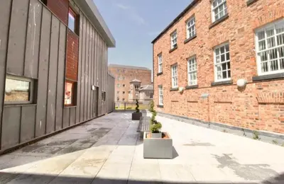 an empty alley between two brick buildings at Campbell Square Apartment 3 in Liverpool