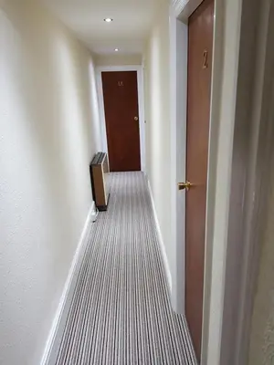 an empty hallway with a door and a box on the floor at The Trentham Hotel in Blackpool