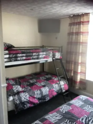 two bunk beds in a room with a bed at The Trentham Hotel in Blackpool