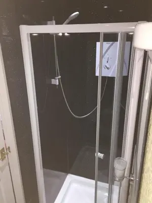 a shower in a bathroom with a glass door at The Trentham Hotel in Blackpool