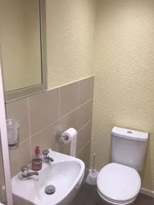 a bathroom with a white toilet and a sink at The Trentham Hotel in Blackpool