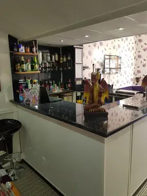 a kitchen with a bar with a statue on the counter at The Trentham Hotel in Blackpool