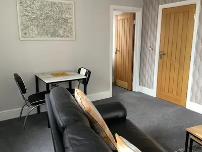 a living room with a couch and a table at Jeffersons Hotel & Serviced Apartments in Barrow in Furness