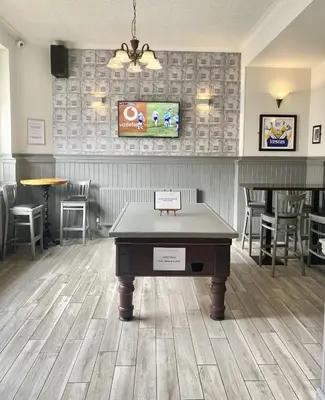 a ping pong table in front of a restaurant at Jeffersons Hotel & Serviced Apartments in Barrow in Furness