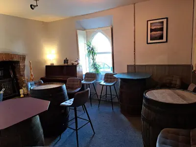 a bar with a bunch of wine barrels in a room at The Ship Inn in Bardsea