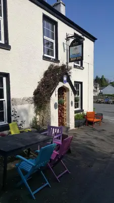 a table and chairs in front of a building at The Ship Inn in Bardsea