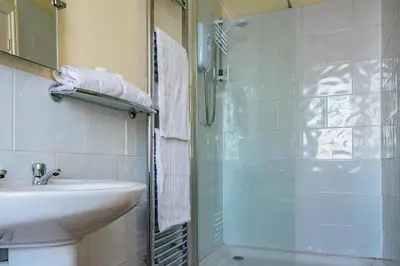 a bathroom with a glass shower and a sink at Bloomfield Brewhouse in Blackpool