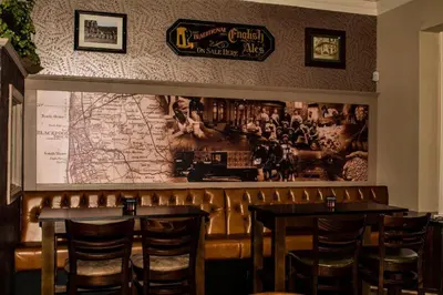 a restaurant with two tables and a map on the wall at Bloomfield Brewhouse in Blackpool