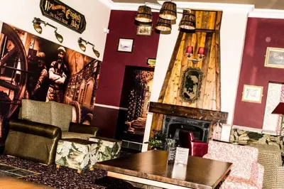 a living room with a couch and a fireplace at Bloomfield Brewhouse in Blackpool